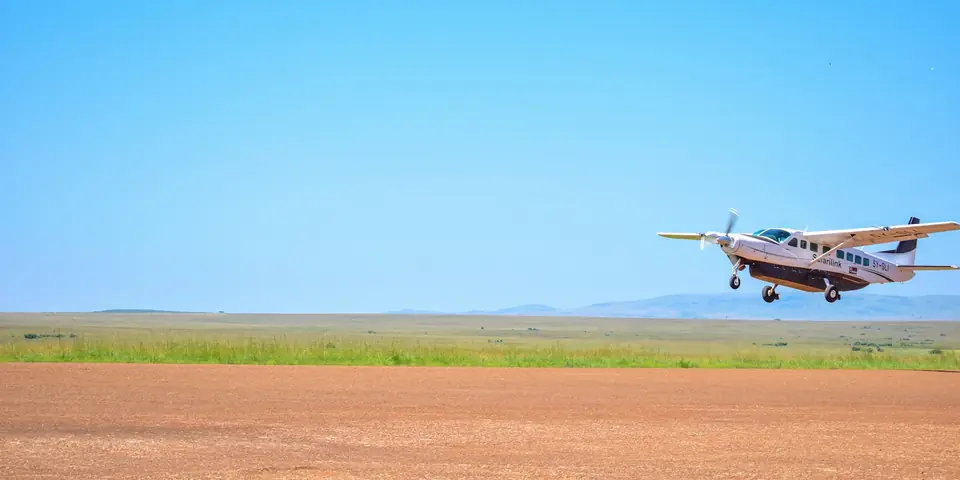 Cessna Caravan plane of the type used on Zanzibar to Serengeti fly-in safari flights, taking off from a dirt airstrip